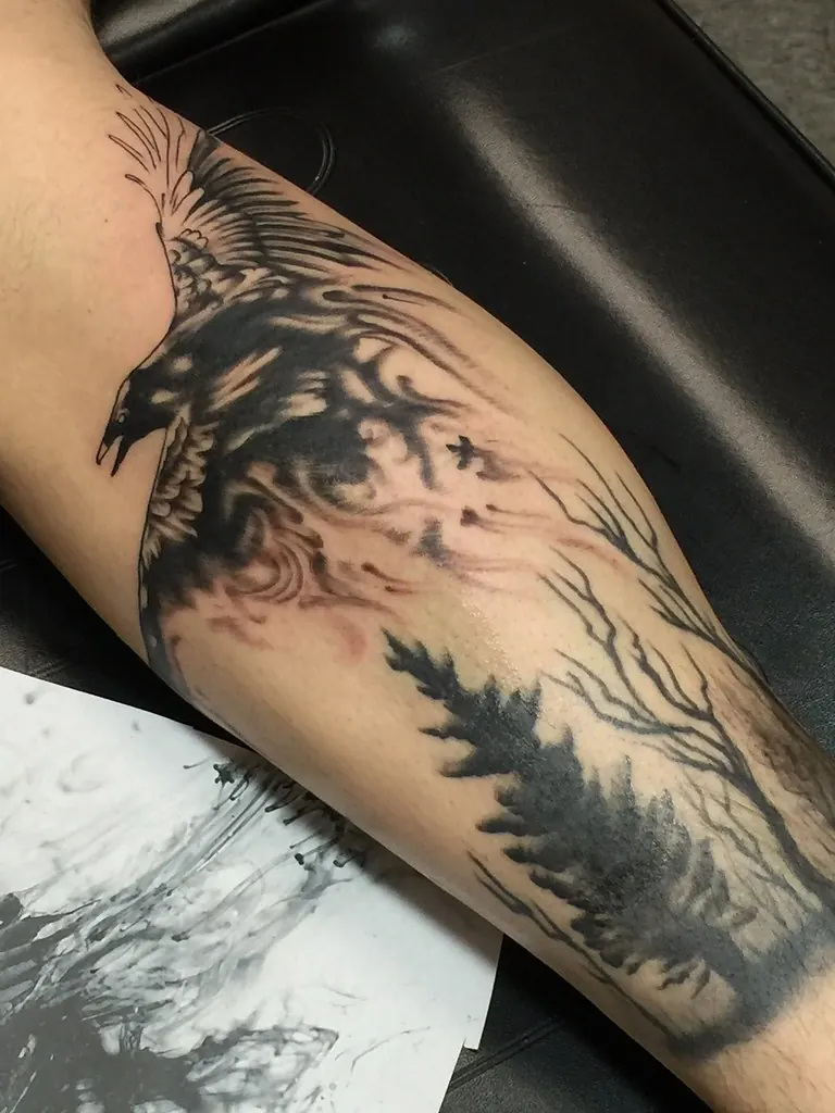 Blackwork raven flying over a pine forest silhouette on the forearm
