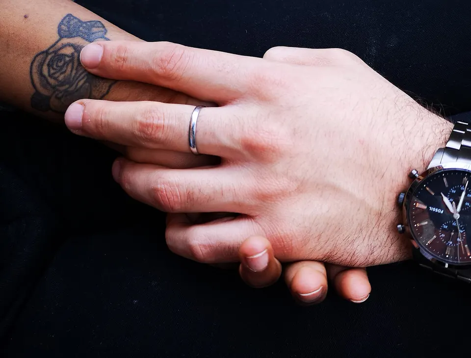 Dark rose tattoo on the back of the hand