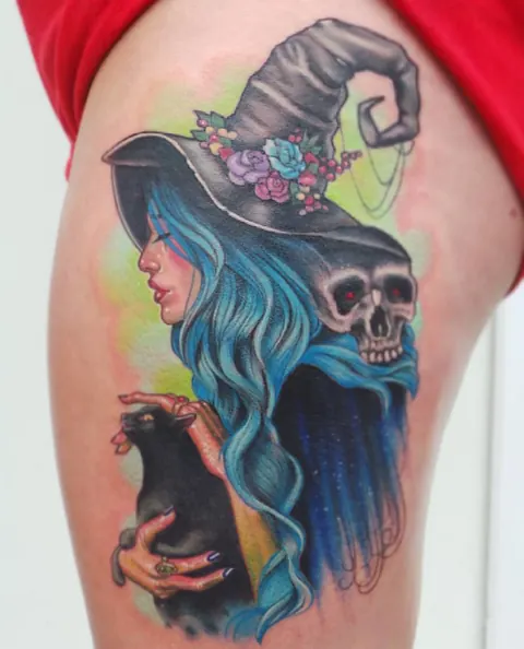Neo-traditional witch with a pointed hat, blue hair, skull and black cat on the thigh