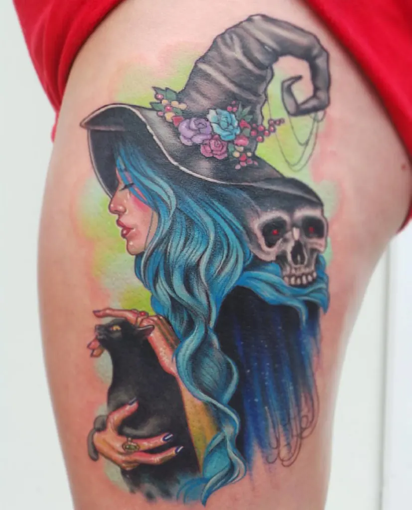 Neo-traditional witch with a pointed hat, blue hair, skull and black cat on the thigh